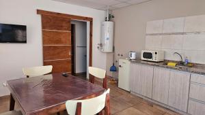 a kitchen with a table and chairs in a kitchen at Departamento Vista Malargüe in Malargüe