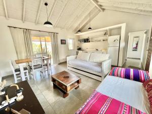 a living room with a couch and a table at Casas Criollas in Chapadmalal