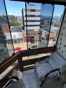 カパン・ダ・カノアにあるApto 604 vibesのバルコニー(椅子付)、大きな窓が備わります。