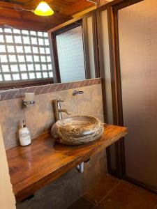 a bathroom with a stone sink on a wooden counter at Parota in Mazamitla