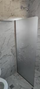 a bathroom with a toilet and a glass door at KUSI Casas de alquiler in Liebig +11 photos