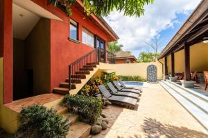 a house with a staircase leading up to a house at Jade Coast 3- Private 5 Bedroom Villa in Tamarindo