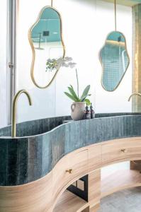 a bathroom with a sink and two mirrors at Uniquely designed 1bd villa with Pvt Pool in Umalas