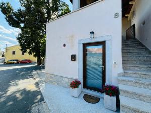 a door on a building with flowers in front of it at Studio Karin in Trviž