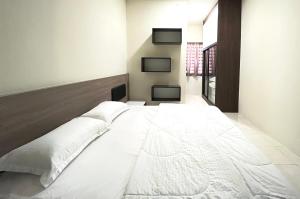 a large white bed in a room at AbelHome in Teluk Intan +3 photos