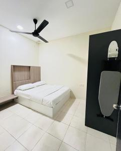 a bedroom with a bed and a ceiling fan at AbelHome in Teluk Intan