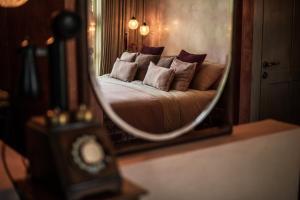 a reflection of a bed in a mirror at Balquisse Heritage Hotel in Jimbaran