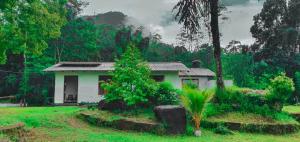 a small house in the middle of a field at Ranpokuna Bungalow with 3 Bed Rooms in Kiriella