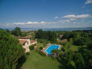 an aerial view of a house with a swimming pool at Daller Bianca Apartment by Wonderful Italy in Soiano del Lago