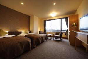 Voodi või voodid majutusasutuse Kintarou Onsen Hotel toas