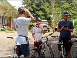 a man taking a picture of two men with bikes at Rezka Roomz Syari'ah in Ende