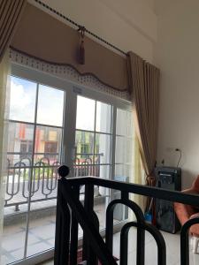 a balcony with a large glass door with a view of a balcony at Ghania homestay syariah meulaboh in Meulaboh