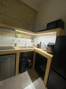 a kitchen with a sink and a counter top at Easter Suite in Acquaviva delle Fonti