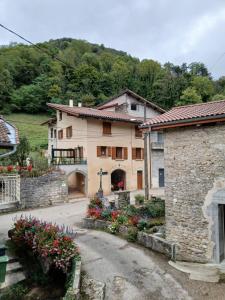 a large building with flowers in front of it at Gite du Vieux Tonneau in Cerdon
