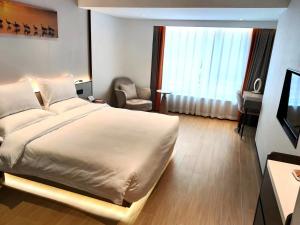 Postel nebo postele na pokoji v ubytování Yun Qi Hotel