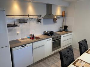 a kitchen with a sink and a stove top oven at Saunallinen iso omakotitalo in Kotka