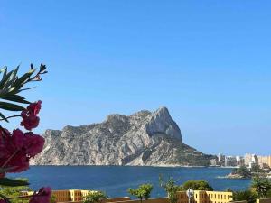 a view of the ocean and a mountain at Espectacular villa junto a la playa, piscina privada y vistas al mar in Calpe +54 photos