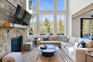 a living room with a couch and a tv at Overlook House home in Telluride