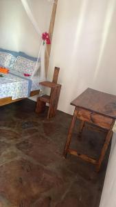 a room with a bed and a table and a bed and a desk at Villa Samaki in Watamu +31 photos