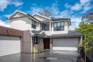 a large white house with a garage at Family Fairyland 4 BRM 3 BATH near Chadstone SC in Oakleigh East
