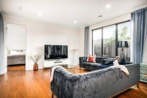 a living room with two couches and a television at Family Fairyland 4 BRM 3 BATH near Chadstone SC in Oakleigh East