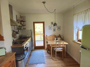 a kitchen with a table and a dining room at Ferienwohnung Alpenblume in Stockach