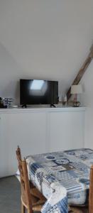 a bedroom with a bed and a tv on a wall at La grange du Manemeur in Quiberon