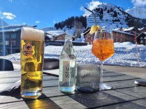 a table with two glasses and a bottle of beer at Ferienwohnung Alpenblume in Stockach