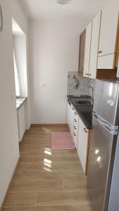 a small kitchen with a sink and a refrigerator at casa LUCIANER in Molveno