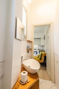 a bathroom with a white sink on a wooden counter at Intero alloggio - Torino Aurora in Turin