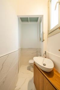 a white bathroom with a sink and a toilet at Intero alloggio - Torino Aurora in Turin