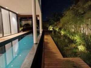 a swimming pool next to a house at night at המטרופולו in Caesarea