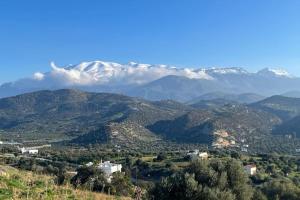 a view of a mountain range with snow covered mountains at Olive Grove Serenity villa in Agia Galini