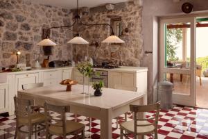 a kitchen with a white table and chairs at La scuola di Anna in Babino Polje