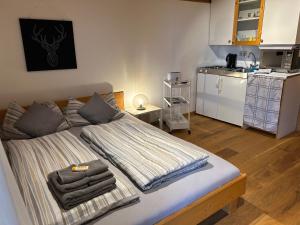 a bedroom with a bed with towels on it at Sonnenuntergang in Traunstein