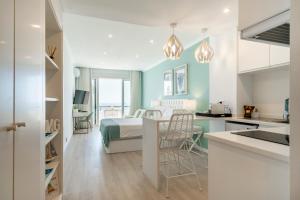 a kitchen and a bedroom with a bed in a room at Sea Lovers - Sea front - studio apartment in Monte Gordo