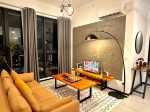 a living room with a couch and a table at Urban Seaview with Infinity Pool, Luxury Modern Stylish 7pax 3Bedroom 3Queen in Jelutong