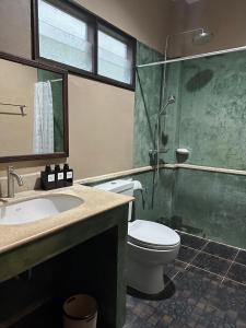 a bathroom with a toilet and a shower and a sink at 103-25 Kathu Waterfall in Phuket +15 photos