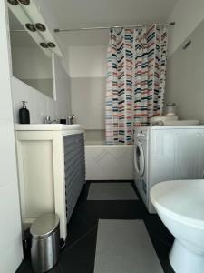 a bathroom with a sink and a washing machine at Ostoja Metro Bródno Warszawa in Warsaw +29 photos