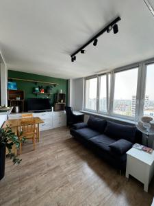 a living room with a couch and a table at Ostoja Metro Bródno Warszawa in Warsaw