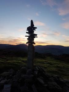 a stack of rocks on top of a hill at Llety'r Post in Crickhowell