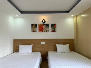 Postel nebo postele na pokoji v ubytování Thanh Hiền HB Hotel