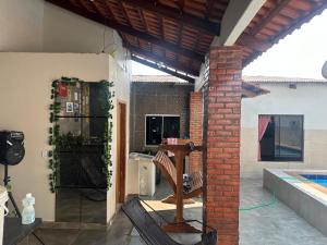 a patio with a brick wall and a table in a house at POUSADA e HOTEL FLORESTA AMAZÔNICA in Nova Emprêsa