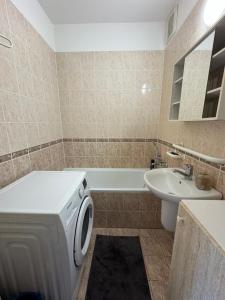 a bathroom with a washing machine and a sink at BLACKWOOD Kitchen in Bratislava +16 photos