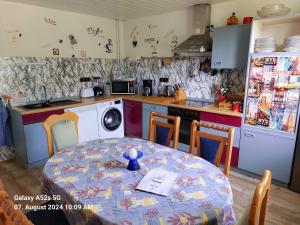 a kitchen with a table and a kitchen with a table and a kitchen at Ferienhaus Kunterbunt in Hitzacker