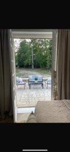 a bedroom with a door open to a patio at Suite parentale in Lamorlaye +30 photos