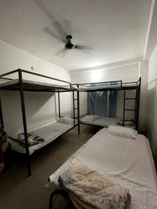 a room with two bunk beds and a ceiling at IK Homestay in Varanasi