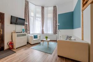 a living room with a couch and a tv at Mirage Apartments Váci Street in Budapest