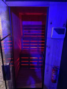 a purple and red lighted stairs in a room at Cinema Paradiso - Appartement de charme avec Sauna, Hammam, spa in Issoudun