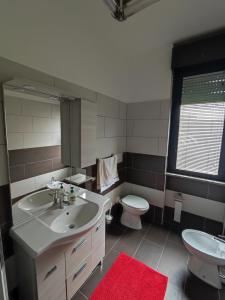 a bathroom with a white sink and a toilet at La suite di Carola in Villasanta +3 photos